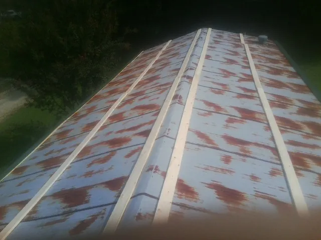 Rusted metal roof panels with new wood purlins before replacement — Storm Damage Roof Repair in Edelstein by Roofing Brothers