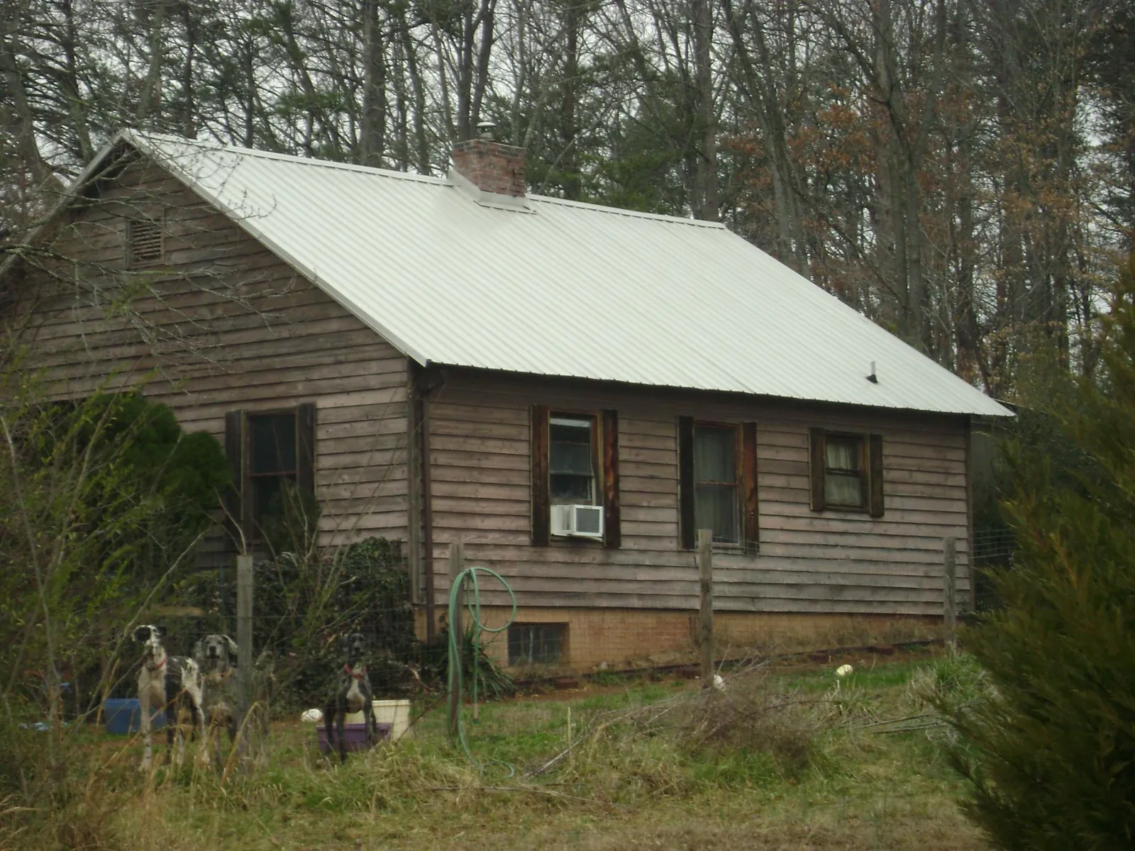 White metal roof on an old wood sided farmhouse, from a Metal Roof Installation job in Edelstein